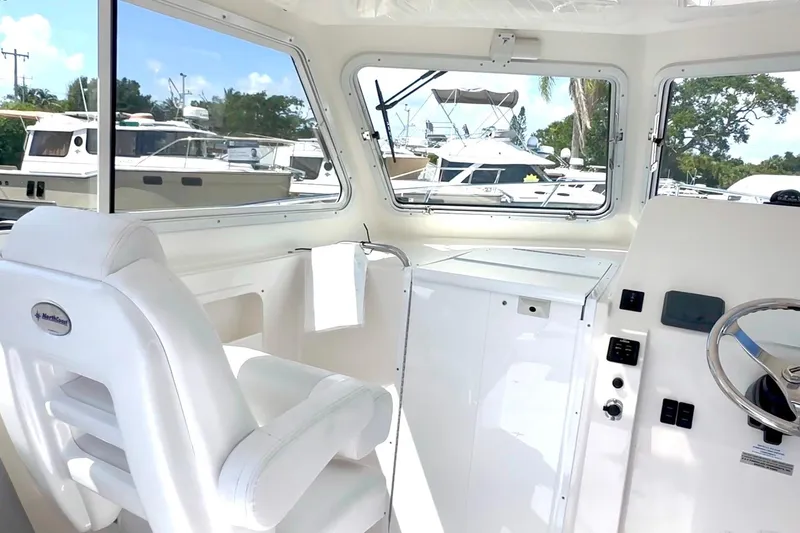 Slide: The Image of 2024 NorthCoast 255HT boat interior with white seating and modern controls. - 17