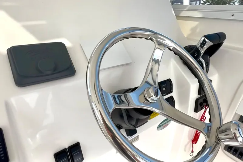 Slide: The Image of 2024 NorthCoast 255HT helm with sleek steering wheel and modern controls. - 21