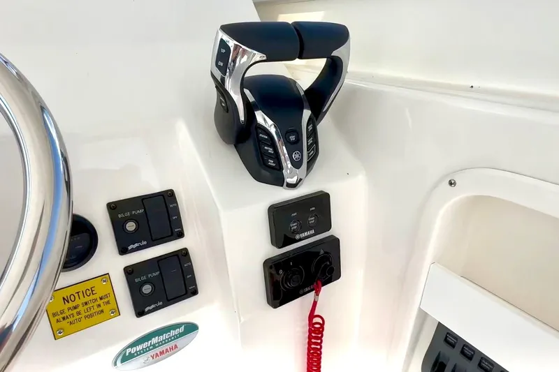 Slide: The Image of 2024 NorthCoast 255HT boat controls with Yamaha throttle and bilge pump switches. - 23