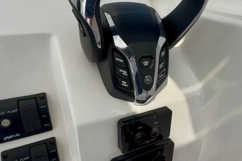 Slide: The Image of 2024 NorthCoast 255HT boat controls featuring Yamaha throttle and bilge pump switches. - 25