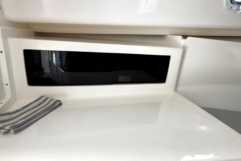 Slide: The Image of 2024 NorthCoast 255HT interior detail with sleek white surface and striped cloth. - 29