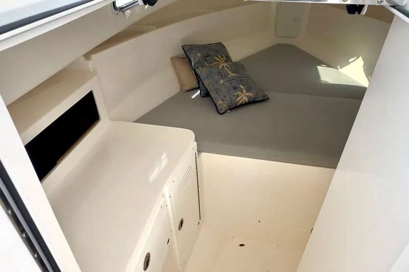 Slide: The Image of 2024 NorthCoast 255HT cabin interior with cushions and storage space. - 32
