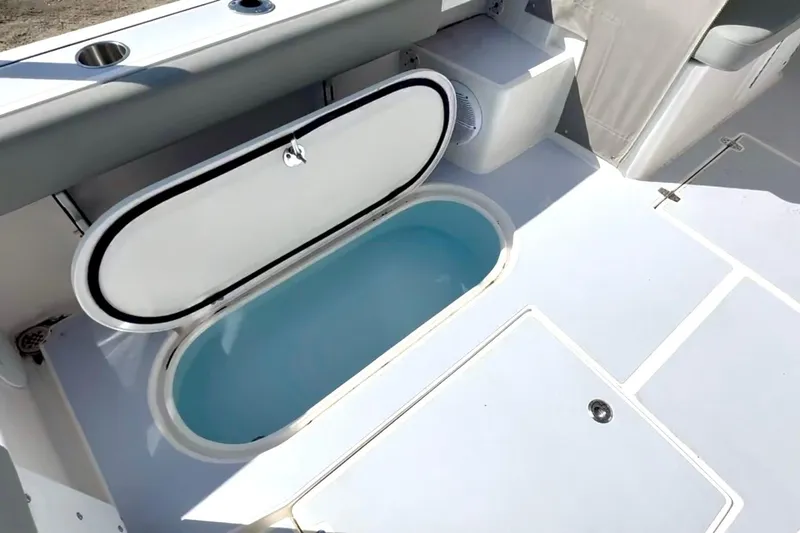 Slide: The Image of 2024 NorthCoast 255HT boat interior with open storage compartment. - 38