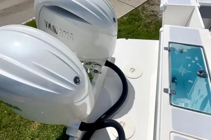 Slide: The Image of 2024 NorthCoast 255HT boat with dual Yamaha outboard engines and a livewell. - 4