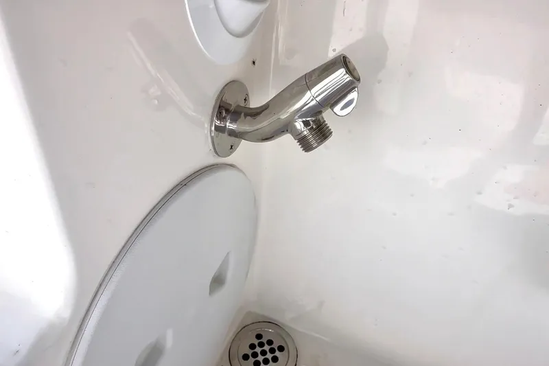 Slide: The Image of 2024 NorthCoast 255HT boat interior with chrome shower fixture and drain. - 40