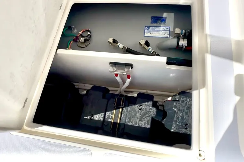 Slide: The Image of 2024 NorthCoast 255HT boat battery compartment with wiring and connections. - 46