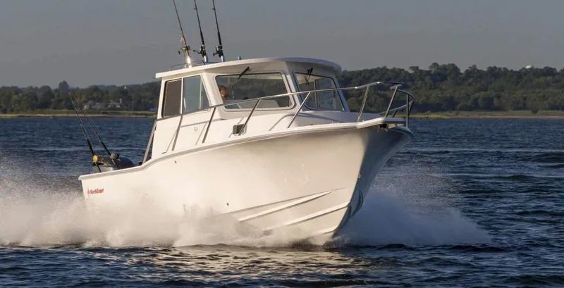 Slide: The Image of 2024 NorthCoast 255HT boat cruising on water with fishing rods. - 7