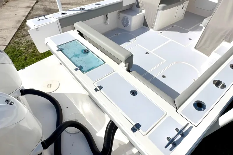 Slide: The Image of 2024 NorthCoast 255HT boat deck with seating, storage, and dual engines. - 8