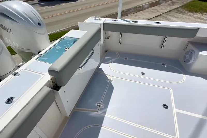 Slide: The Image of 2024 NorthCoast 255HT boat deck with seating and storage compartments. - 9