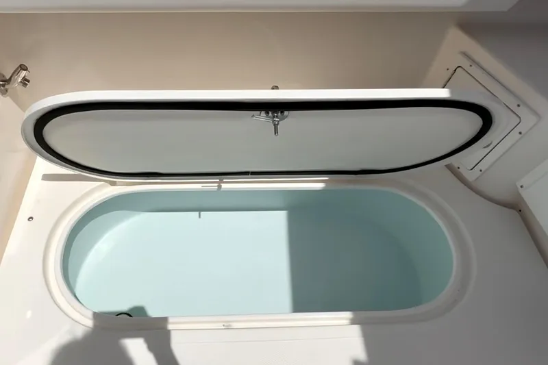 Slide: The Image of Open hatch on 2024 NorthCoast 285HT boat, revealing storage compartment. - 10