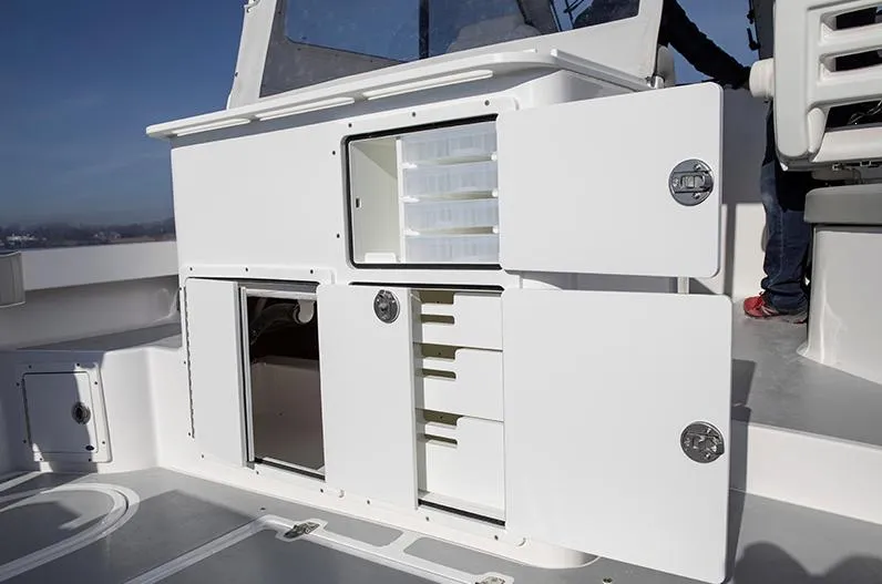 Slide: The Image of 2024 NorthCoast 285HT boat interior with open storage compartments and shelves. - 12