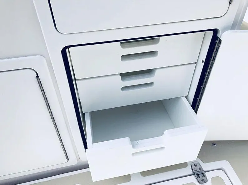 Slide: The Image of 2024 NorthCoast 285HT boat storage drawers, open and empty, showcasing interior organization. - 13