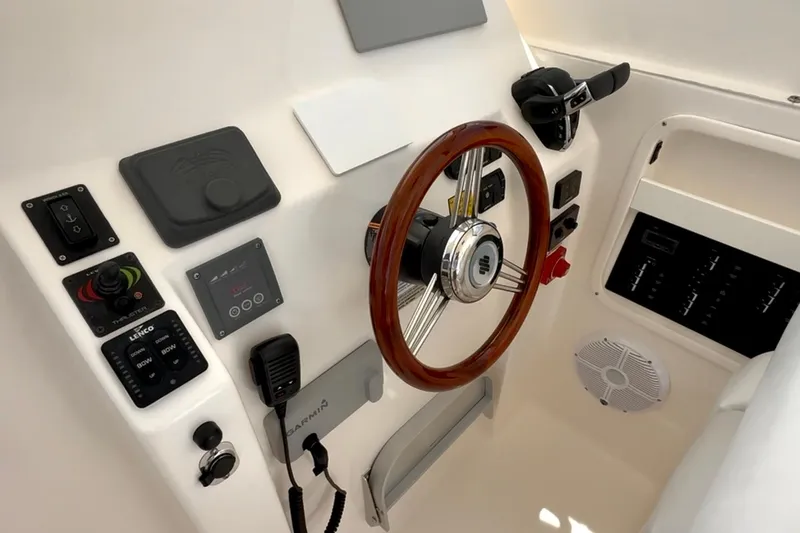 Slide: The Image of 2024 NorthCoast 285HT helm with wooden steering wheel and modern controls. - 18