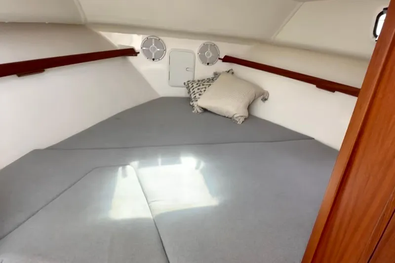 Slide: The Image of 2024 NorthCoast 285HT cabin interior with cushions and wooden accents. - 23