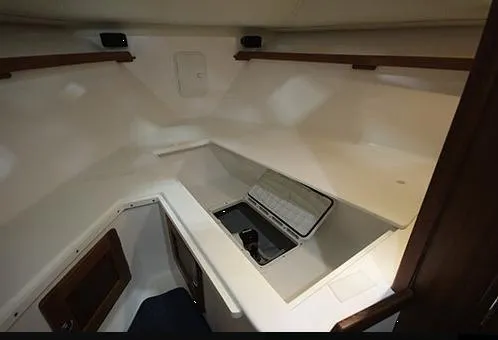 Slide: The Image of 2024 NorthCoast 285HT cabin interior with storage compartment and wooden accents. - 29