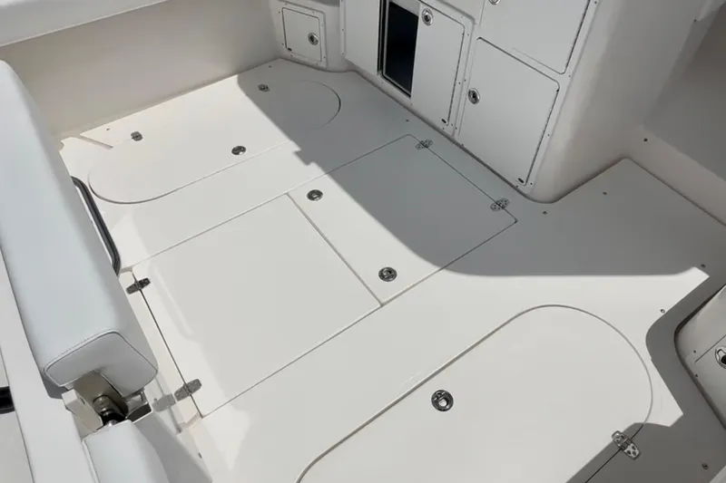 Slide: The Image of 2024 NorthCoast 285HT boat interior with storage compartments and seating. - 3