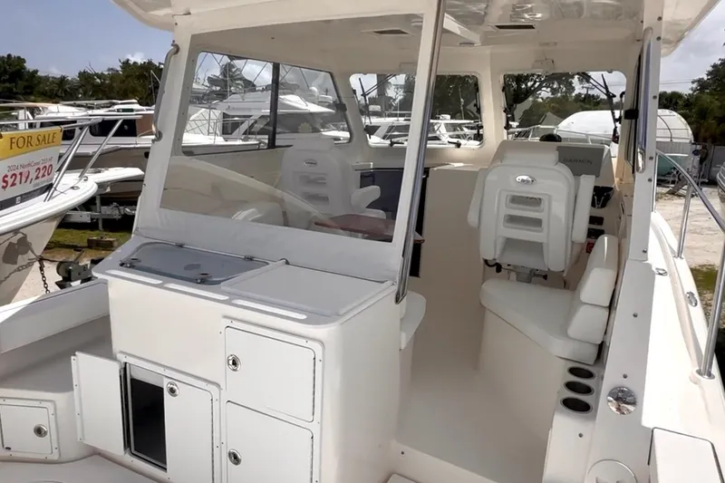 Slide: The Image of 2024 NorthCoast 285HT boat interior with seating and helm, for sale. - 5