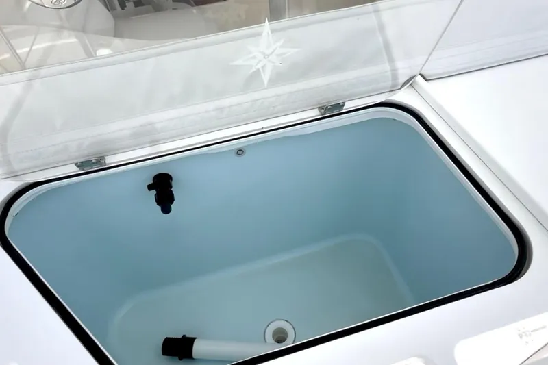Slide: The Image of 2024 NorthCoast 285HT boat livewell with open lid, showcasing interior design. - 9