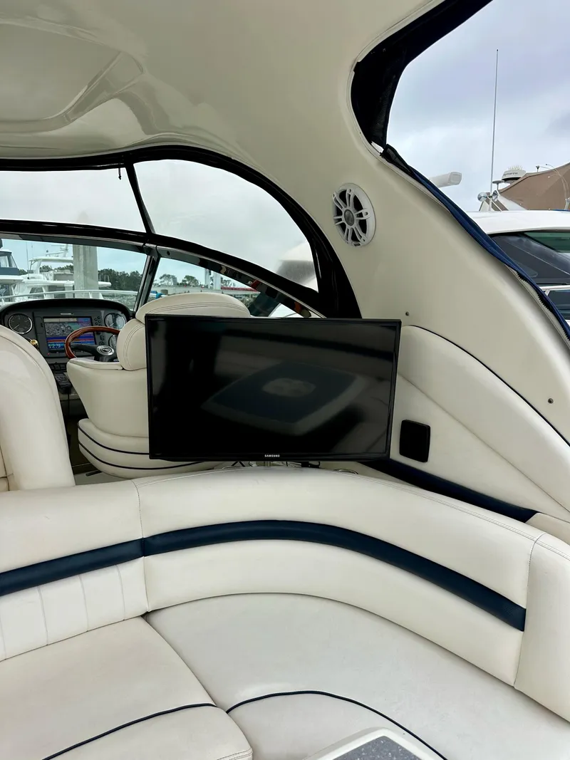 Slide: The Image of Interior of 2006 Sea Ray 44 Sundancer yacht with TV and white seating. - 12