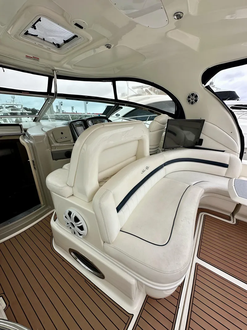 Slide: The Image of 2006 Sea Ray 44 Sundancer interior with white seating and wood flooring. - 13