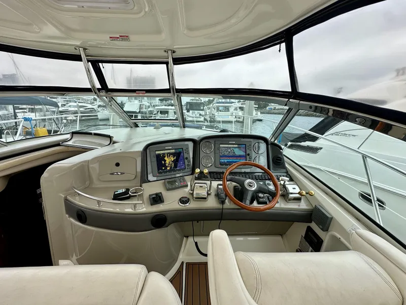 Slide: The Image of Helm of 2006 Sea Ray 44 Sundancer with navigation equipment and wooden steering wheel. - 14