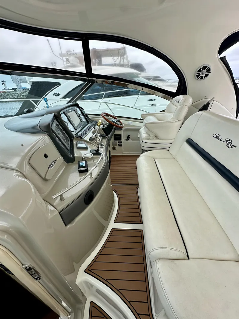Slide: The Image of 2006 Sea Ray 44 Sundancer yacht interior with luxurious seating and modern dashboard. - 19