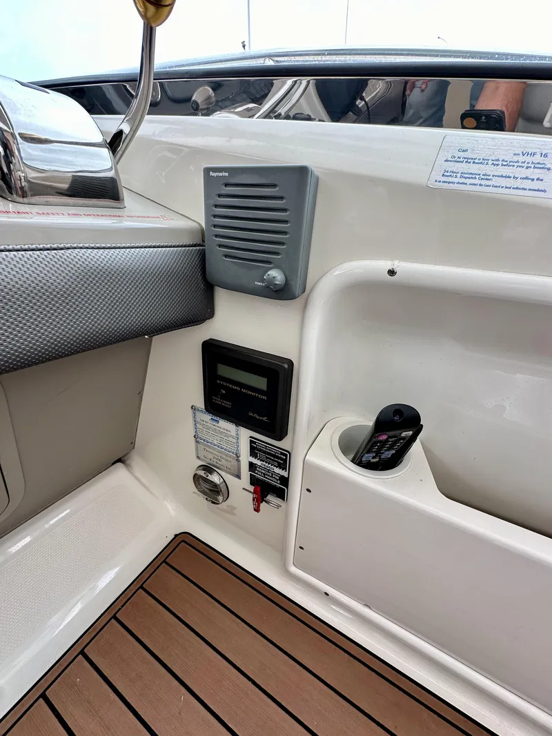 Slide: The Image of 2006 Sea Ray 44 Sundancer cockpit with control panel and speaker system. - 21