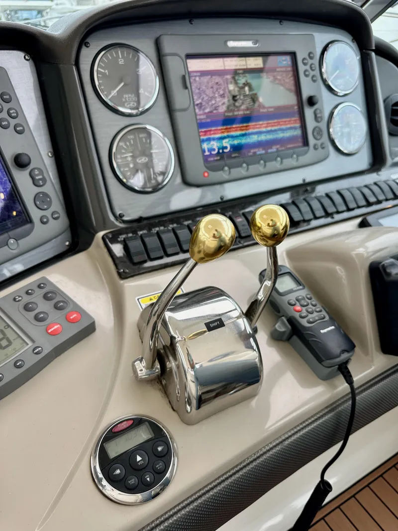 Slide: The Image of Control panel of a 2006 Sea Ray 44 Sundancer yacht with navigation instruments. - 24