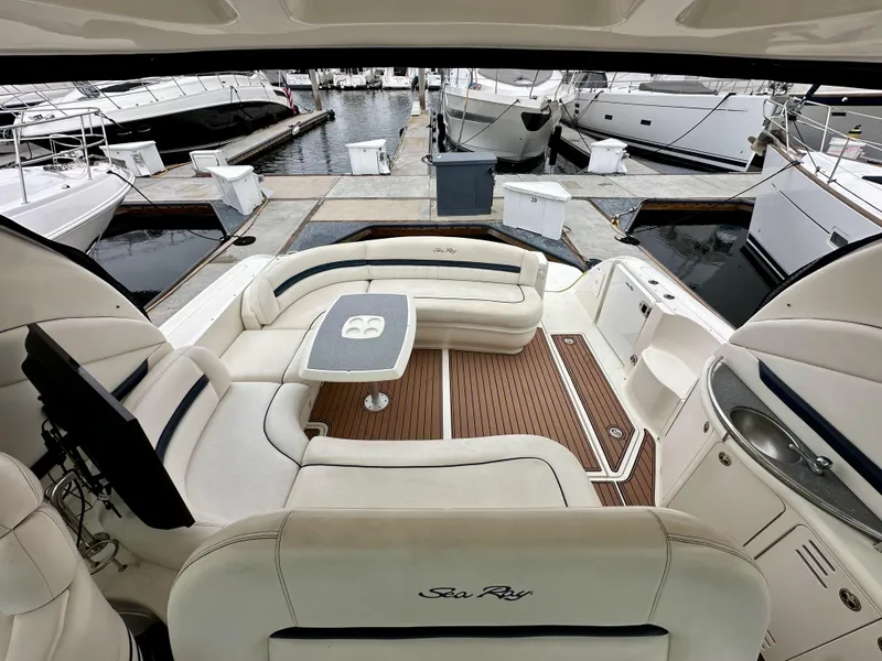 Slide: The Image of 2006 Sea Ray 44 Sundancer yacht interior with elegant seating and table at marina. - 26