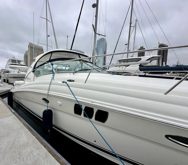 Slide: The Image of 2006 Sea Ray 44 Sundancer yacht docked at marina, overcast sky. - 3
