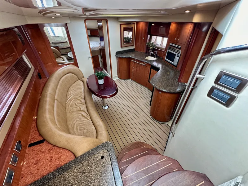 Slide: The Image of Interior of 2006 Sea Ray 44 Sundancer yacht with luxurious seating and modern kitchen. - 31