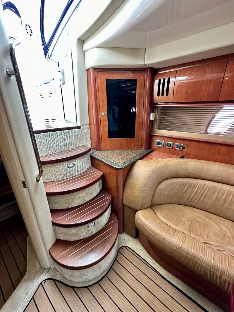 Slide: The Image of Interior of 2006 Sea Ray 44 Sundancer with wooden stairs and leather seating. - 32