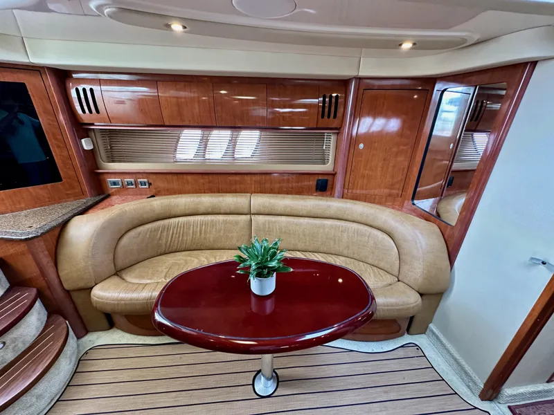 Slide: The Image of Interior of 2006 Sea Ray 44 Sundancer yacht with leather seating and wooden table. - 35