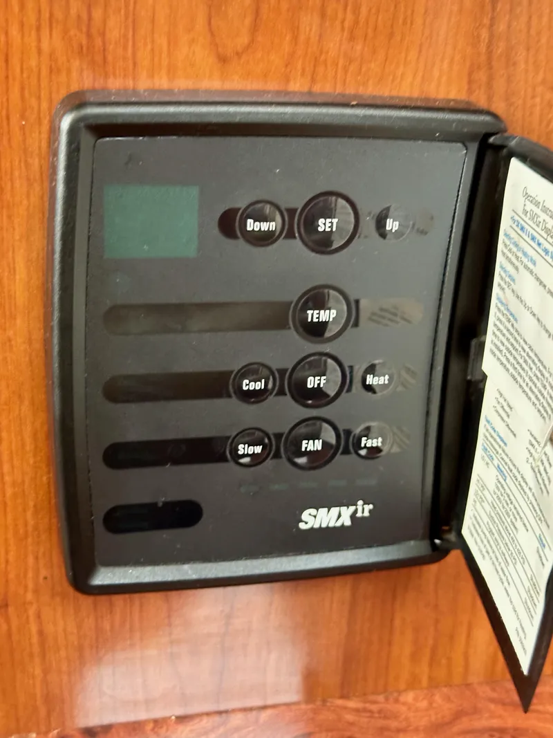 Slide: The Image of Control panel on a 2006 Sea Ray 44 Sundancer boat, featuring temperature and fan settings. - 36