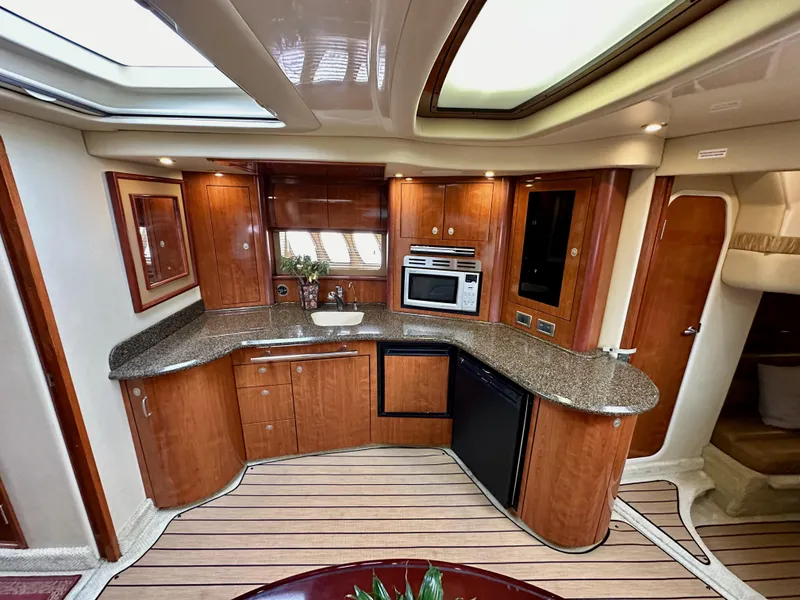 Slide: The Image of Luxurious kitchen interior of 2006 Sea Ray 44 Sundancer yacht with wood cabinetry. - 37