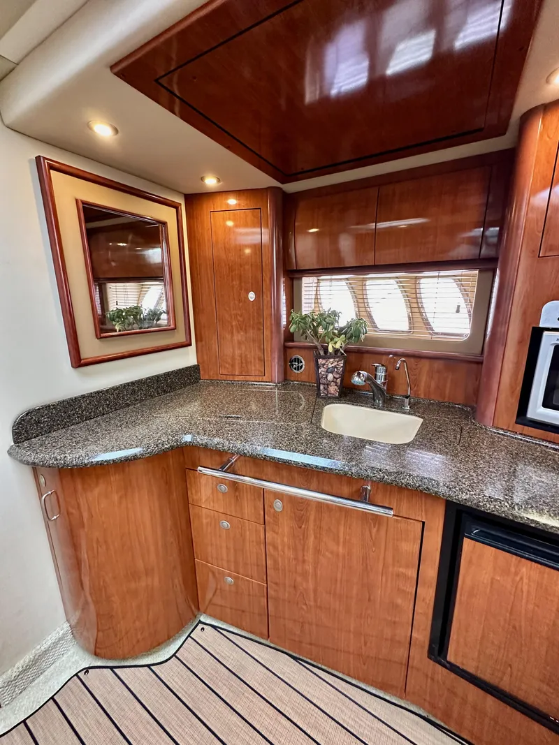 Slide: The Image of Luxurious 2006 Sea Ray 44 Sundancer yacht interior with elegant wood cabinetry and modern amenities. - 39