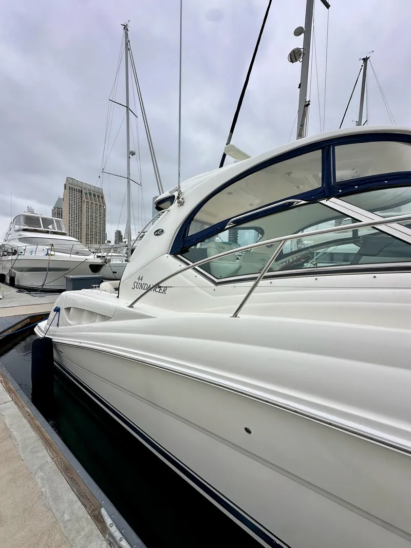 Slide: The Image of 2006 Sea Ray 44 Sundancer yacht docked at marina, overcast sky. - 4
