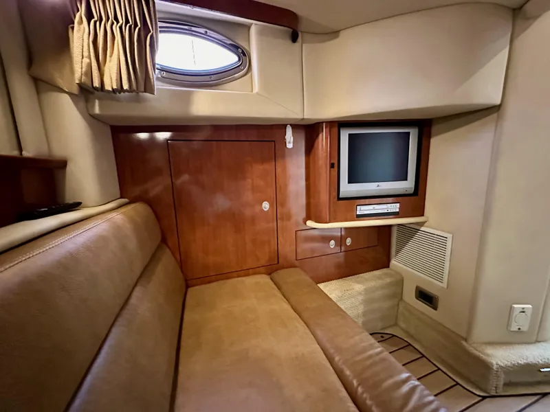 Slide: The Image of 2006 Sea Ray 44 Sundancer cabin interior with TV and seating area. - 45