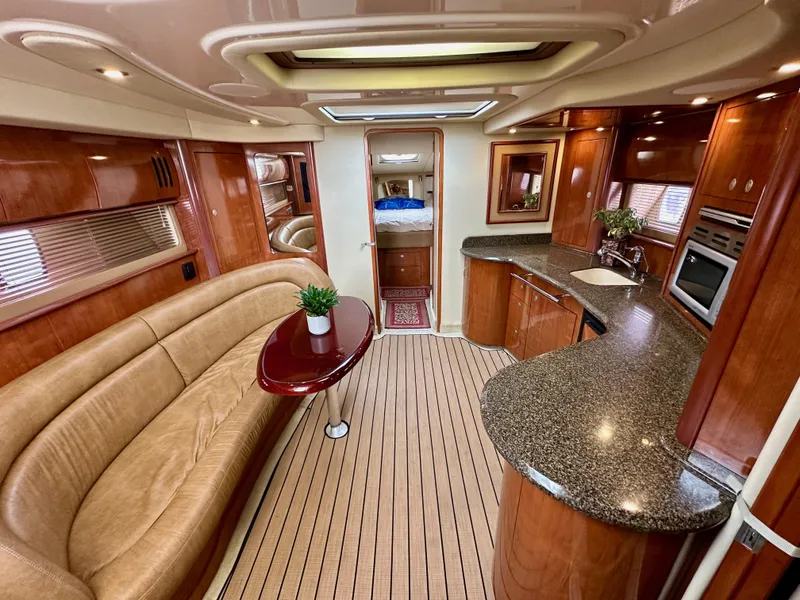 Slide: The Image of Luxurious interior of 2006 Sea Ray 44 Sundancer yacht with elegant wood finishes and modern amenities. - 48