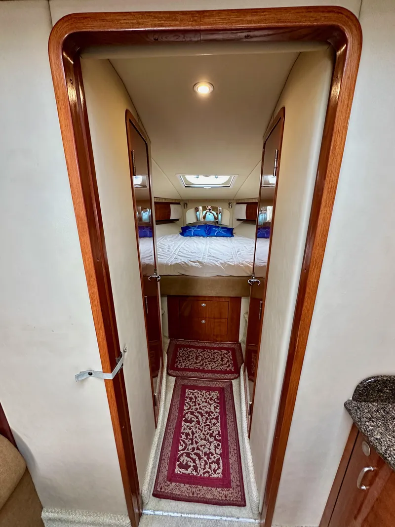 Slide: The Image of Interior cabin of 2006 Sea Ray 44 Sundancer yacht with bed and decorative rug. - 49
