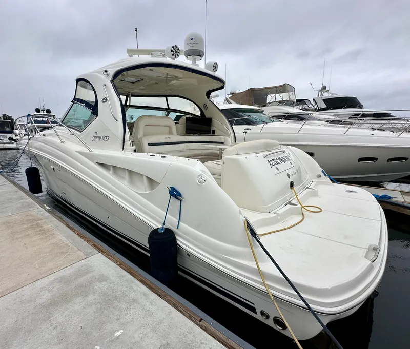 Slide: The Image of 2006 Sea Ray 44 Sundancer yacht docked at marina, featuring sleek design and spacious deck. - 6