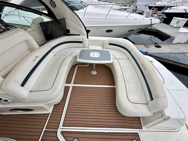 Slide: The Image of 2006 Sea Ray 44 Sundancer yacht with elegant seating and wooden deck. - 9