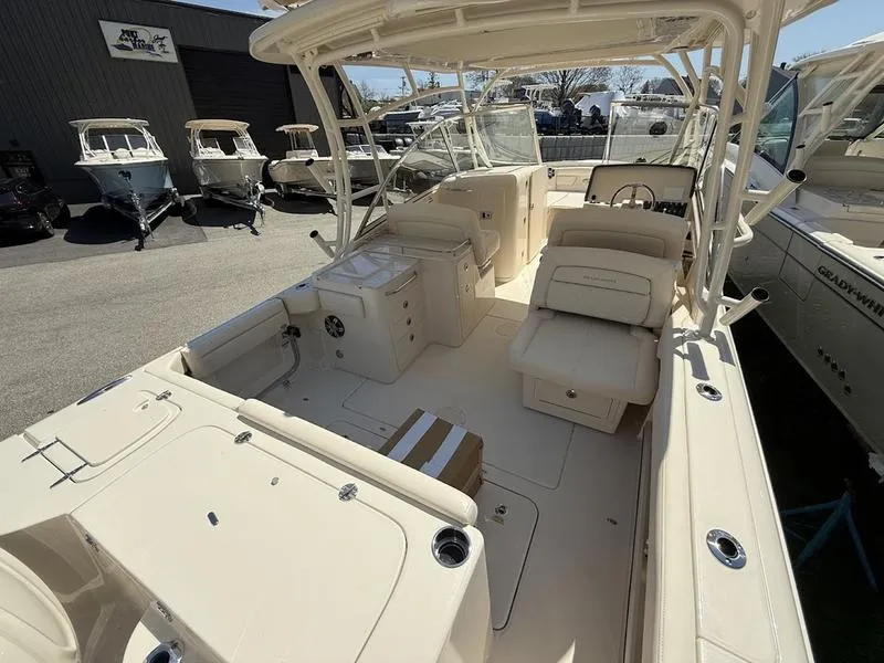 Slide: The Image of 2025 Grady-White Freedom 285 boat interior with seating and helm, displayed outdoors. - 5