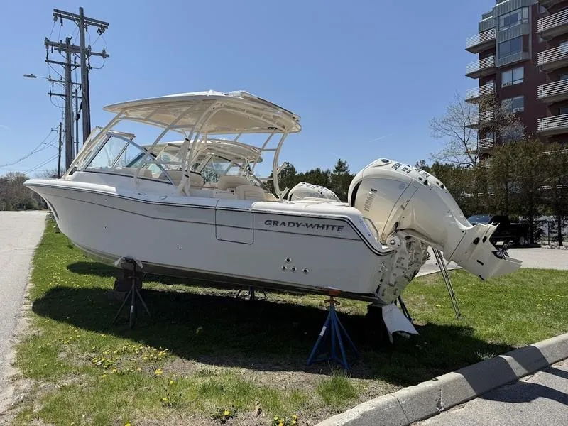 Slide: The Image of 2025 Grady-White Freedom 285 boat on display, parked on grass near a building. - 7