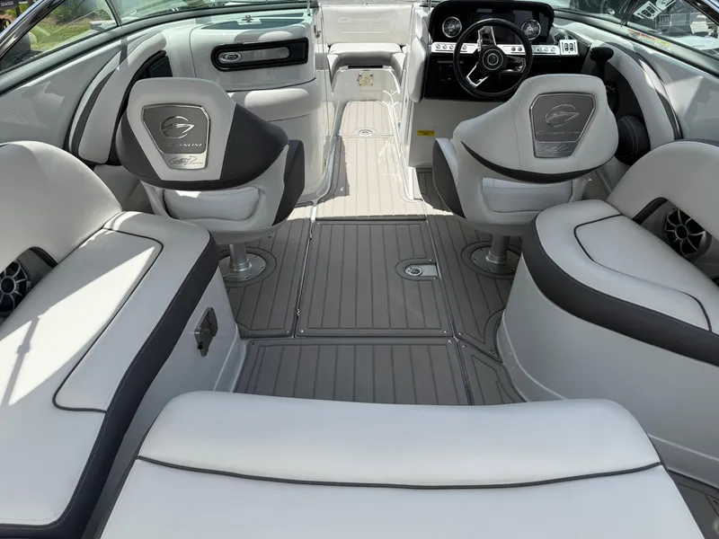 Slide: The Image of 2023 Crownline 250 XSS boat interior with luxurious seating and modern dashboard. - 11