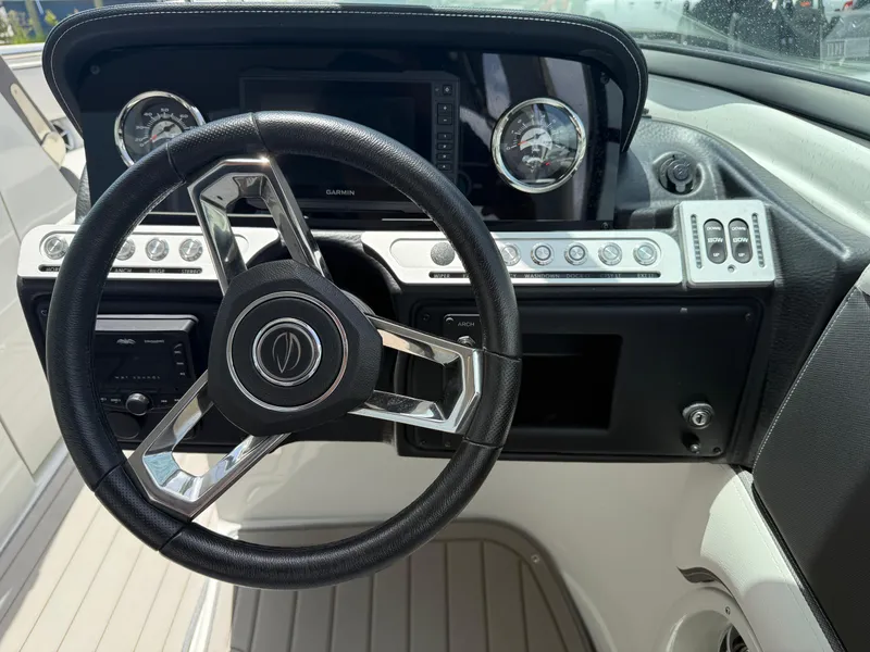 Slide: The Image of Steering wheel and dashboard of 2023 Crownline 250 XSS boat. - 13