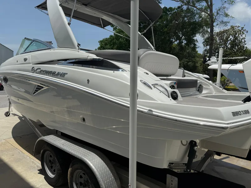 Slide: The Image of 2023 Crownline 250 XSS boat on trailer, sleek design, white exterior, outdoor setting. - 3