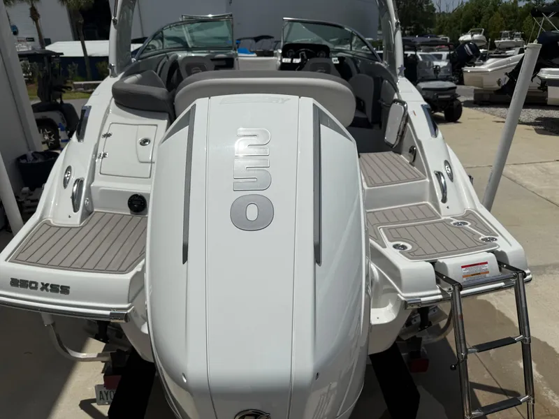 Slide: The Image of 2023 Crownline 250 XSS boat, rear view with swim platform and ladder. - 5