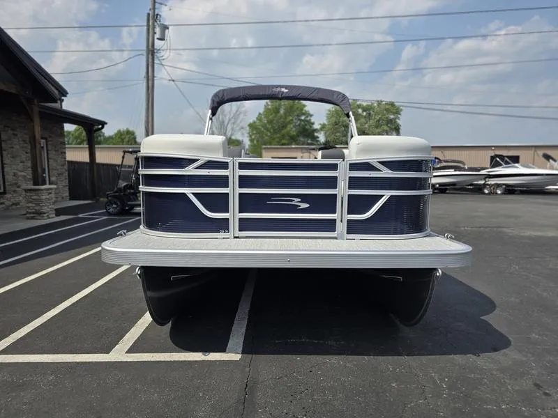Slide: The Image of 2025 Bennington 20 SL pontoon boat parked outdoors on a sunny day. - 3
