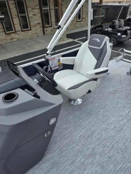 Slide: The Image of 2025 Bennington 20 SL boat interior with modern captain's chair and sleek dashboard design. - 9